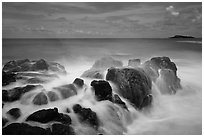 Rock with water motion and Mokuaeae island. Kauai island, Hawaii, USA ( black and white)