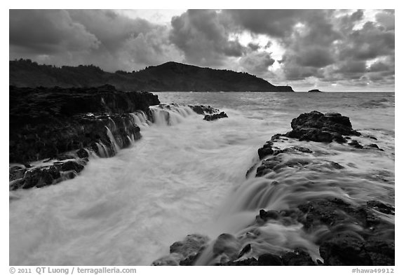 Lava bench gorge and surf at sunset, Mokolea Peninsula. Kauai island, Hawaii, USA