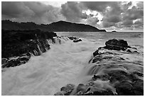 Lava bench gorge and surf at sunset, Mokolea Peninsula. Kauai island, Hawaii, USA ( black and white)