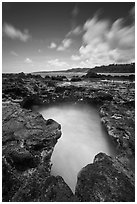 Surf in blowhole, Mokolea lava shelf. Kauai island, Hawaii, USA (black and white)