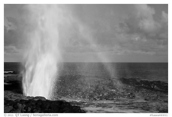 Spouting Horn with rainbow, late afternoon. Kauai island, Hawaii, USA