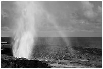 Spouting Horn with rainbow, late afternoon. Kauai island, Hawaii, USA (black and white)