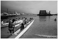 Kamakahonu Beach with outrigger canoeists, Kailua-Kona. Hawaii, USA (black and white)