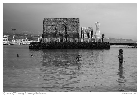 Women snorkling and Kamakahonu heiau, Kailua-Kona. Hawaii, USA (black and white)