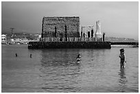 Women snorkling and Kamakahonu heiau, Kailua-Kona. Hawaii, USA ( black and white)