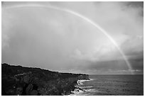 Rainbow over volcanic costline. Big Island, Hawaii, USA (black and white)