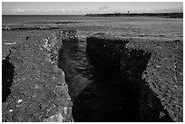 Walled stream flowing into Kiholo Bay. Big Island, Hawaii, USA ( black and white)