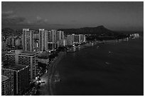 Aerial view of Waikiki Beach, skyline, and Diamond Head at night. Honolulu, Oahu island, Hawaii, USA ( black and white)