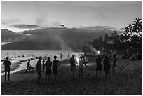 Revelers on Kamahole Beach with fireworks, Kihei. Maui, Hawaii, USA ( black and white)