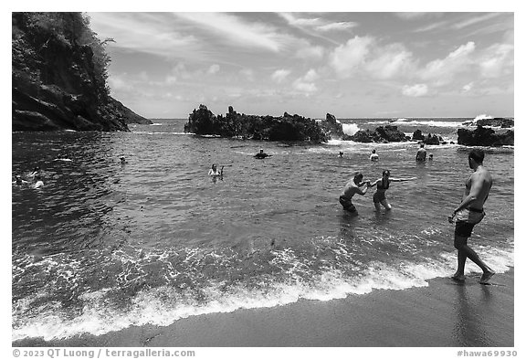 Beach-goers at Red Sand Beach, Hana. Maui, Hawaii, USA