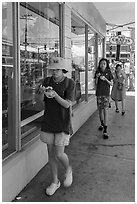 Family walking with Hawaiian Shave Ice, Paia. Maui, Hawaii, USA ( black and white)