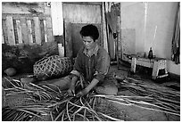 Woman weaving a toga (mat) out of pandamus leaves. American Samoa ( black and white)