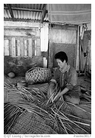 Woman weaving a toga (mat) out of pandamus leaves. American Samoa (black and white)