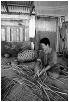 Woman weaving a toga (mat) out of pandamus leaves. American Samoa (black and white)