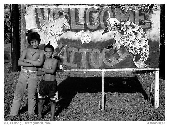 Children in front of a turtle a shark sign in Vaitogi. Tutuila, American Samoa (black and white)