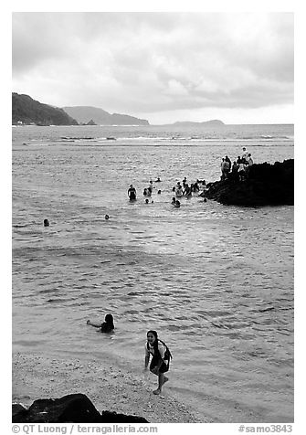 Children playing in water near Fugaalu. Pago Pago, Tutuila, American Samoa
