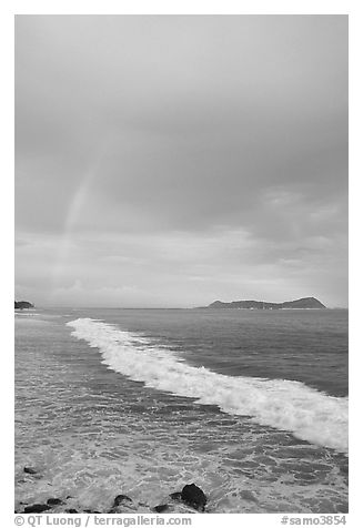 Rainbow at sunset, wave, and Aunuu island. Aunuu Island, American Samoa (black and white)