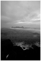 Sunset over Aunuu island with crab on basalt rock. Aunuu Island, American Samoa ( black and white)