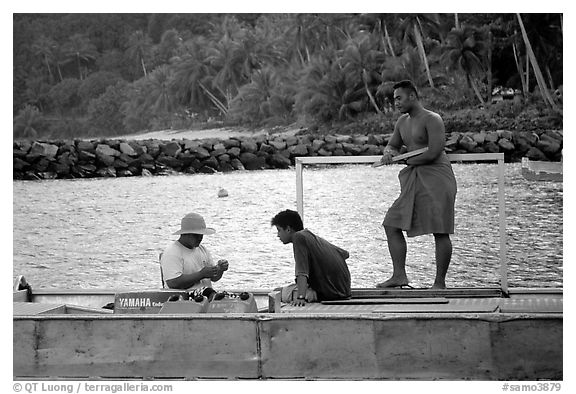 Men on a ferry to Aunuu. Aunuu Island, American Samoa (black and white)