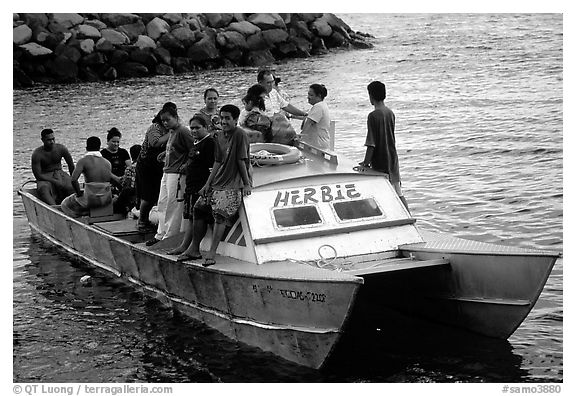 Villagers crowd a ferry to Aunuu. Aunuu Island, American Samoa (black and white)