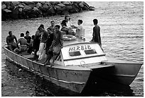 Villagers crowd a ferry to Aunuu. Aunuu Island, American Samoa (black and white)