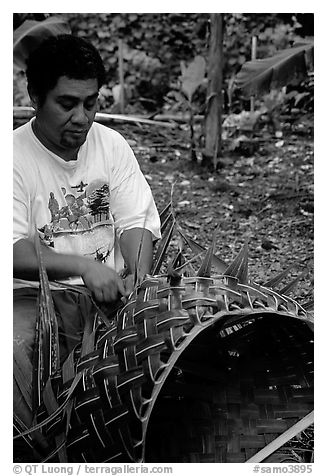 Villager weaving a basket out of a single palm leaf. Tutuila, American Samoa (black and white)