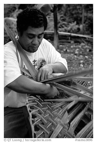 Villager weaving a basket out of a single palm leaf. Tutuila, American Samoa (black and white)
