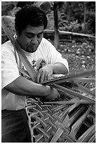 Villager weaving a basket out of a single palm leaf. Tutuila, American Samoa (black and white)