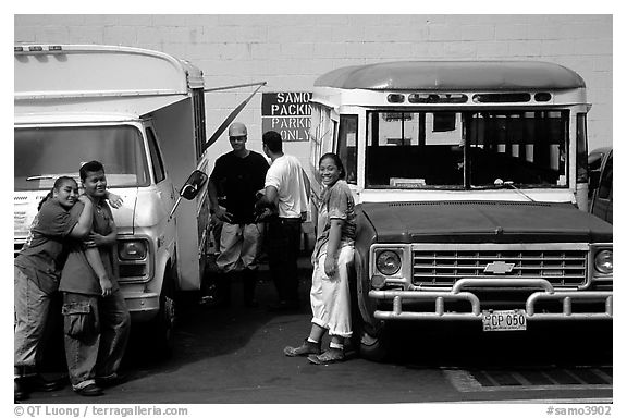 People and colorful buses. Pago Pago, Tutuila, American Samoa (black and white)