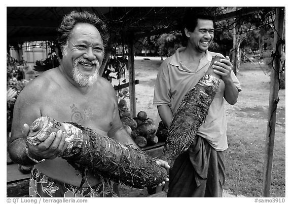Islanders holding Taro roots in Iliili. Tutuila, American Samoa (black and white)