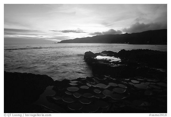 Ancient grinding stones (foaga) and Leone Bay at sunset. Tutuila, American Samoa (black and white)