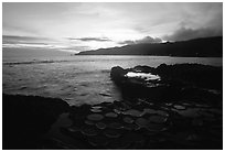 Ancient grinding stones (foaga) and Leone Bay at sunset. Tutuila, American Samoa ( black and white)