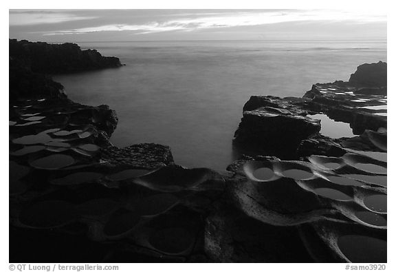 Ancient grinding stones (foaga) and Leone Bay at dusk. Tutuila, American Samoa (black and white)