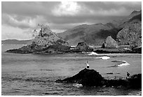 Fishermen on the rocky shore near Maa Kamela. Tutuila, American Samoa (black and white)