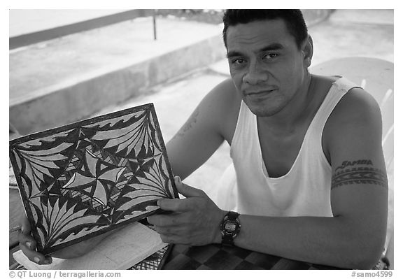 Young man showing an artwork based on traditional siapo designs. Pago Pago, Tutuila, American Samoa (black and white)