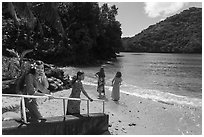 Young samoan women walking down to beach in Fagasa Bay. Tutuila, American Samoa ( black and white)
