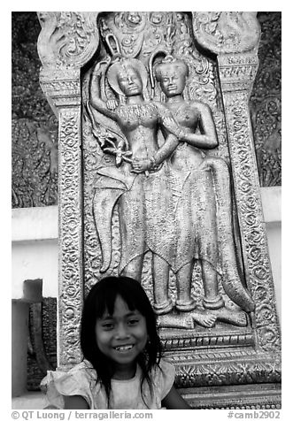 Girl and sculpture at Wat Phnom. Phnom Penh, Cambodia
