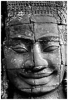 Enigmatic stone smiling face, the Bayon. Angkor, Cambodia (black and white)