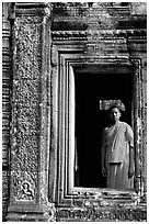 Buddhist monk in doorway, the Bayon. Angkor, Cambodia (black and white)