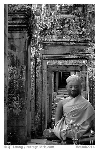 Buddha image, swathed in reverence, with offerings, the Bayon. Angkor, Cambodia (black and white)