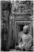 Buddha image, swathed in reverence, with offerings, the Bayon. Angkor, Cambodia (black and white)