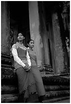 Elegant young women near temple entrance. Angkor, Cambodia (black and white)