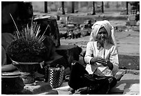Incence vendor wearing traditional headcloth. Angkor, Cambodia ( black and white)