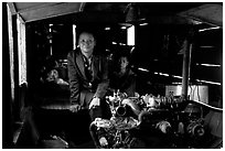 Engine and pilot at the rear of a slow passenger boat. Mekong river, Laos ( black and white)