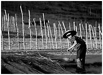 Villager and fence. Mekong river, Laos (black and white)