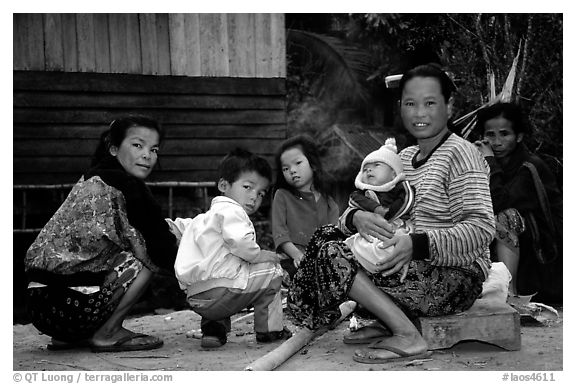 Group of women and children in a small hamlet. Mekong river, Laos (black and white)