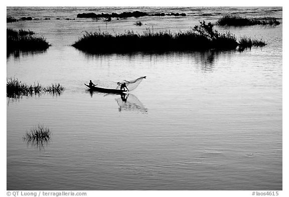 Fisherman casts net at sunset in Huay Xai. Laos (black and white)