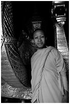 Buddhist novice monk, grinning because demonstrating ordained monks style of robe draping. Luang Prabang, Laos (black and white)