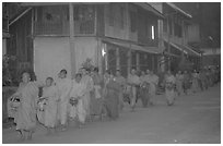 Morning alms procession of buddhist monks. Luang Prabang, Laos (black and white)