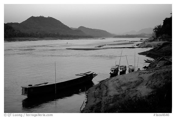 Dusk on the Mekong river framed by coconut trees. Luang Prabang, Laos